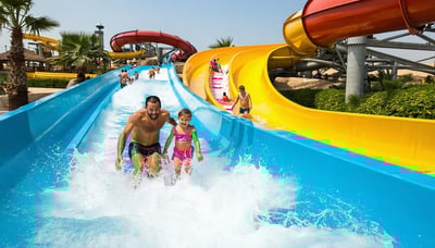 Families enjoying water slides at a vibrant UAE water park Families enjoying water slides at a vibrant UAE water park
